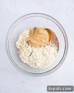 No-Bake Peanut Butter Oat Cups Recipe 10 ingredients for peanut butter protein oat cups placed in a bowl.