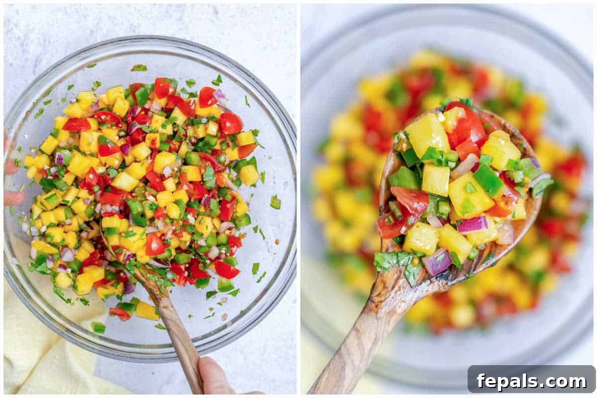 mango pico de gallo being mixed in a bowl.