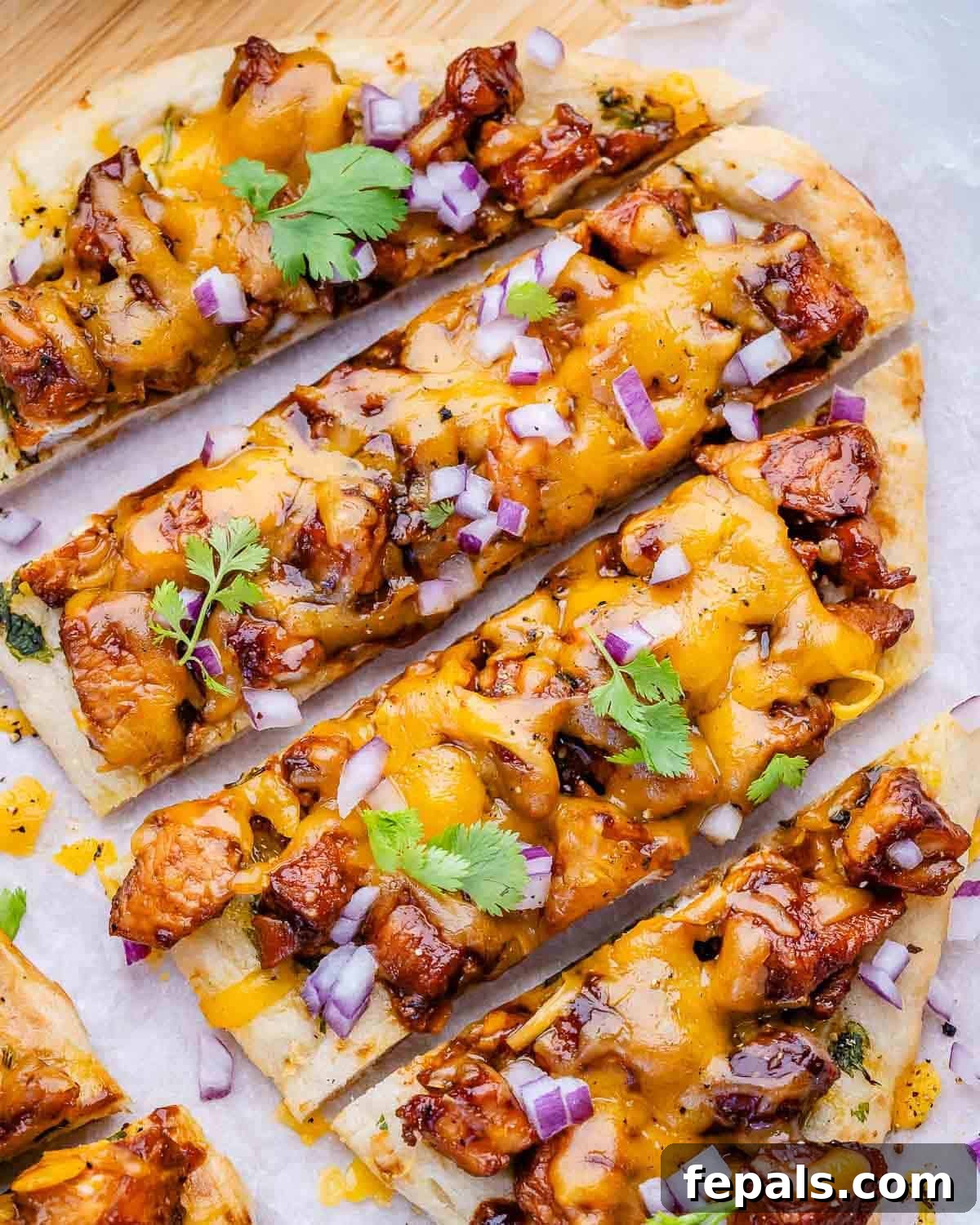 Quick BBQ Chicken Flatbread Recipe for Weeknight Dinner 2 sliced bbq chicken flatbread topped with some chopped cilantro.