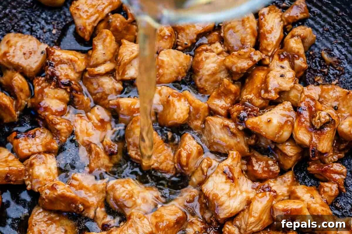 Quick BBQ Chicken Flatbread Recipe for Weeknight Dinner 5 pouring broth over bbq chicken in a pan.