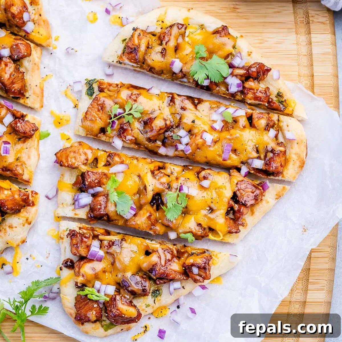 Quick BBQ Chicken Flatbread Recipe for Weeknight Dinner 9 sliced bbq chicken flatbread on parchment paper.