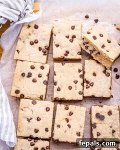 Soft Chewy Chocolate Chip Cookie Bars Recipe 15 cookie bars being cooled on a flat surface.