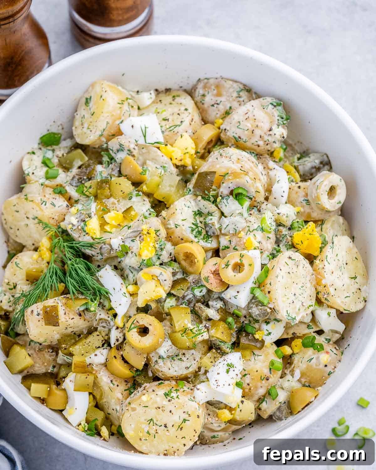 potato salad with pickles in a bowl.