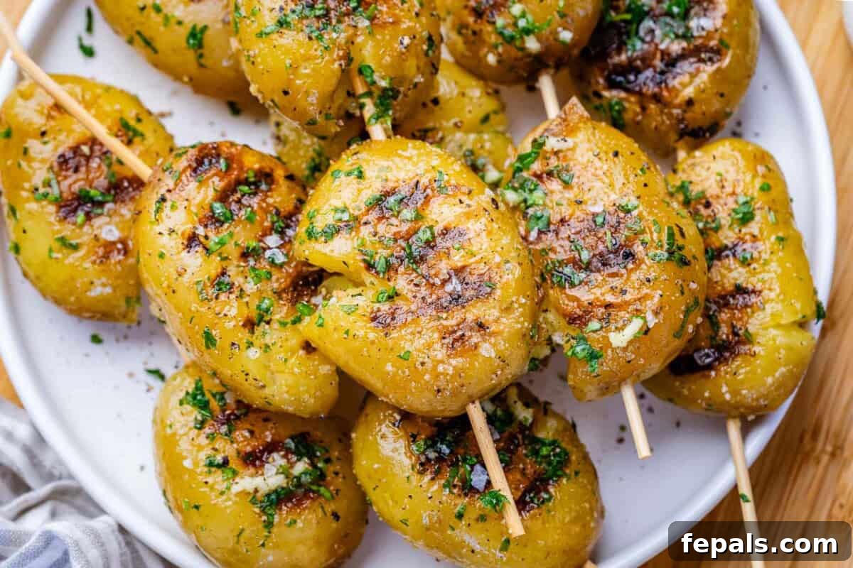 grilled potatoes on skewers on a plate.