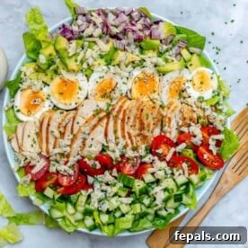 25 Chicken Meal Prep Recipes for Quick, Flavorful Weeknight Meals 20 top view of a round bowl with chicken cobb salad and wooden serving spoon next to it