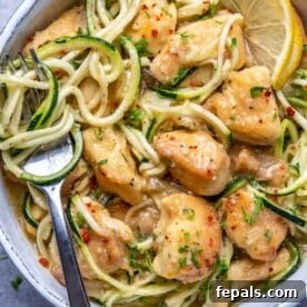 25 Chicken Meal Prep Recipes for Quick, Flavorful Weeknight Meals 22 top view of chicken scampi with fork in the zoodle bowl