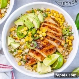 25 Chicken Meal Prep Recipes for Quick, Flavorful Weeknight Meals 5 top view bowl with cauliflower rice topped with sliced grilled chicken breast with corn avocado and sliced jalapeno