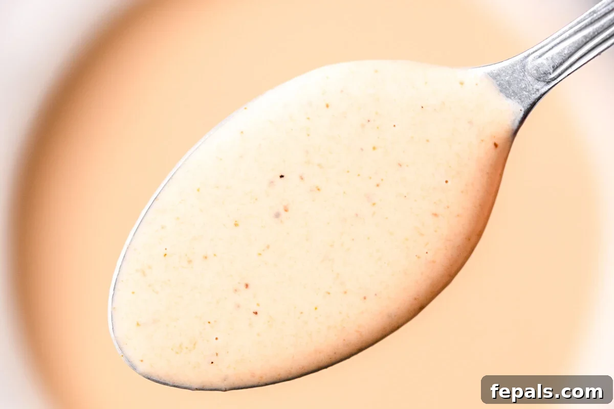 Homemade Copycat Raising Cane’s Sauce Recipe That Nails the Taste 6 spoonful of cane sauce in a bowl.