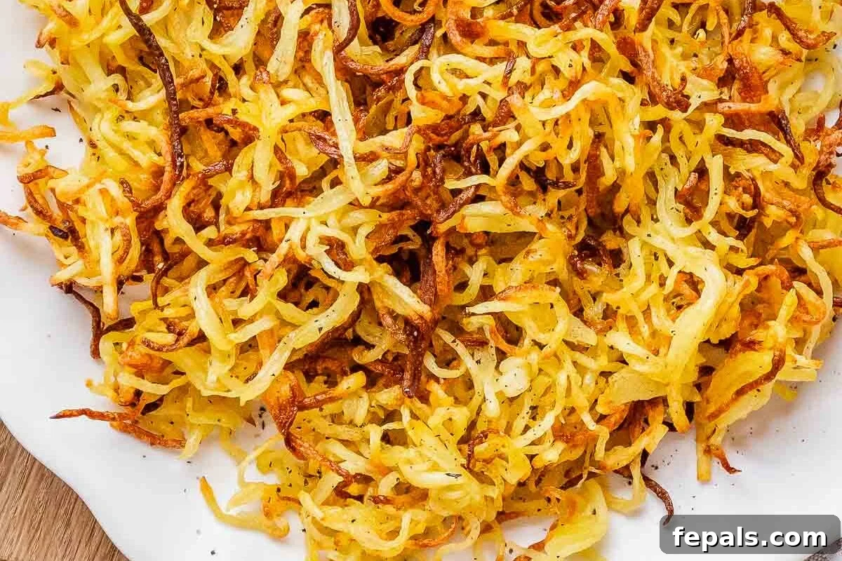 Crispy Air Fryer Frozen Hash Browns Recipe 6 air fryer hash browns on a plate.