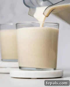 Pouring protein shake into a cup.
