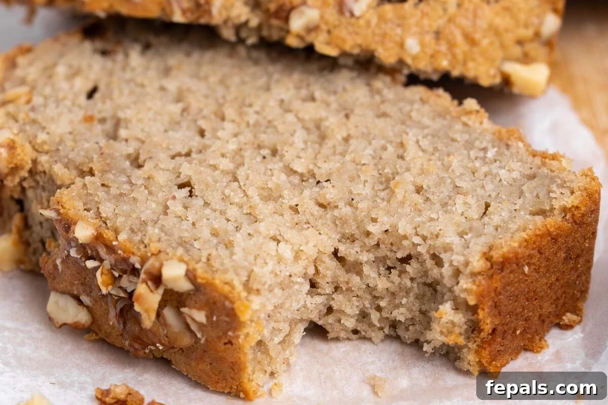 apple sauce bread slice on a cutting board with a bite taken off.