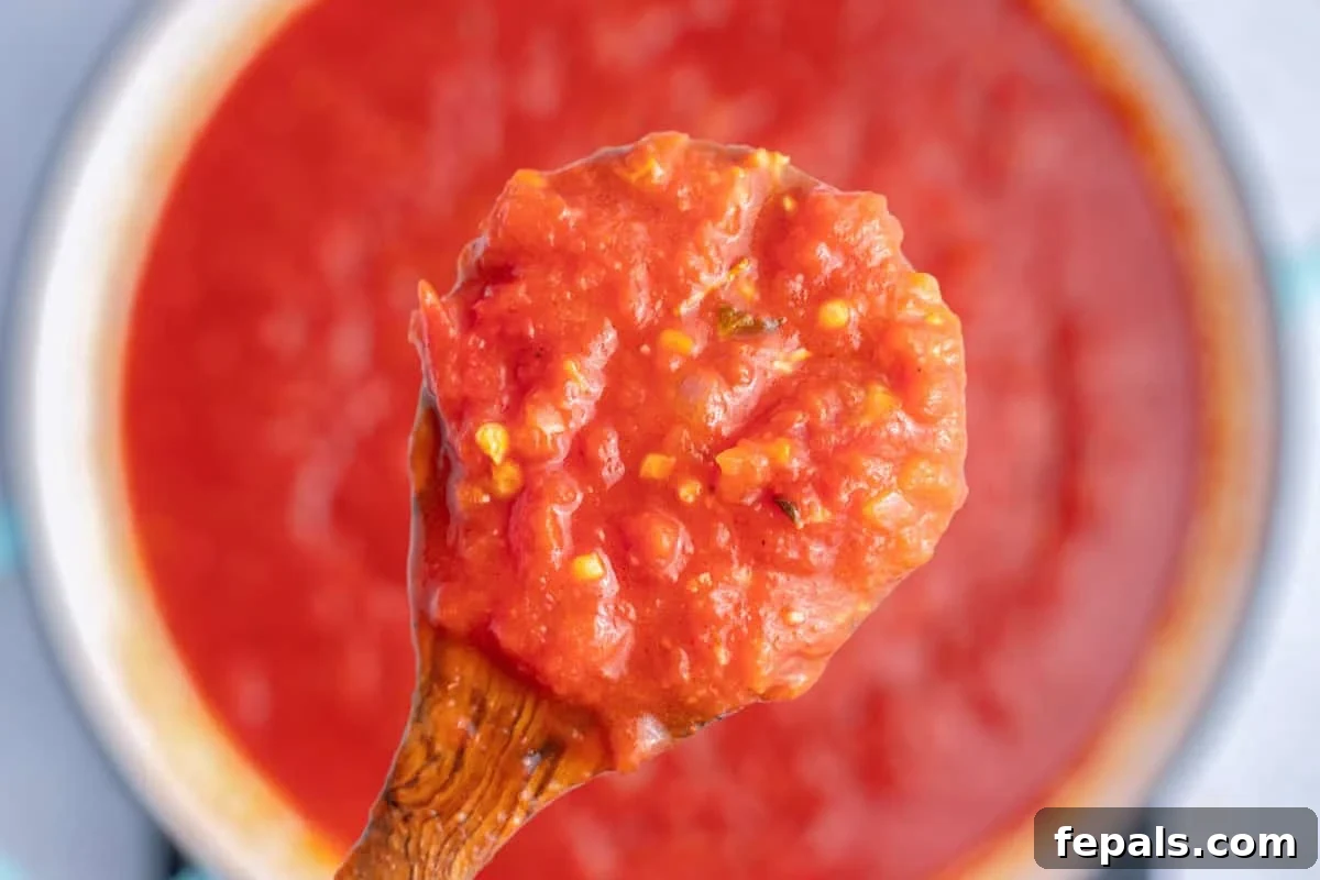 spoonful of arrabbiata over a pan.