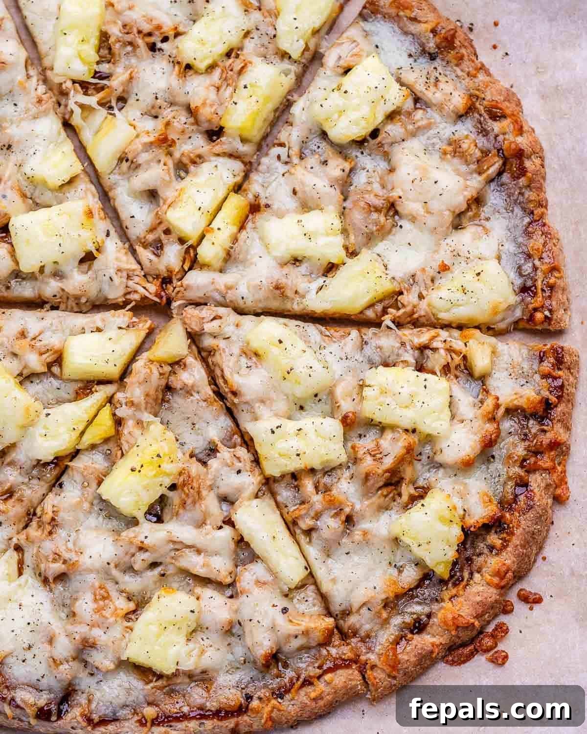 BBQ chicken pizza with pineapple chunks.