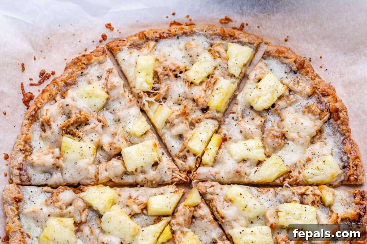Sliced BBQ chicken pizza topped with pineapple.