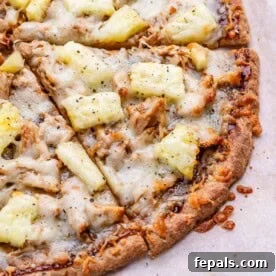 bbq chicken pizza slices topped with pineapple and melted cheese.