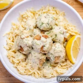 greek chicken meatballs cooked in a creamy sauce served over cooked orzo.