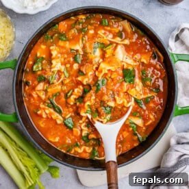 a pot with vegetarian lasagna and a spoon in the pot.