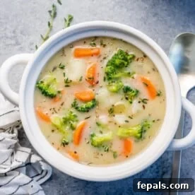 top view of a white round bowl of creamy vegetable soup