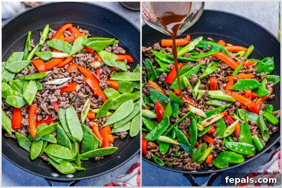 adding the snap peas over the veggies and ground beef then pouring the soy sauce mix over it to cook with the ground beef.