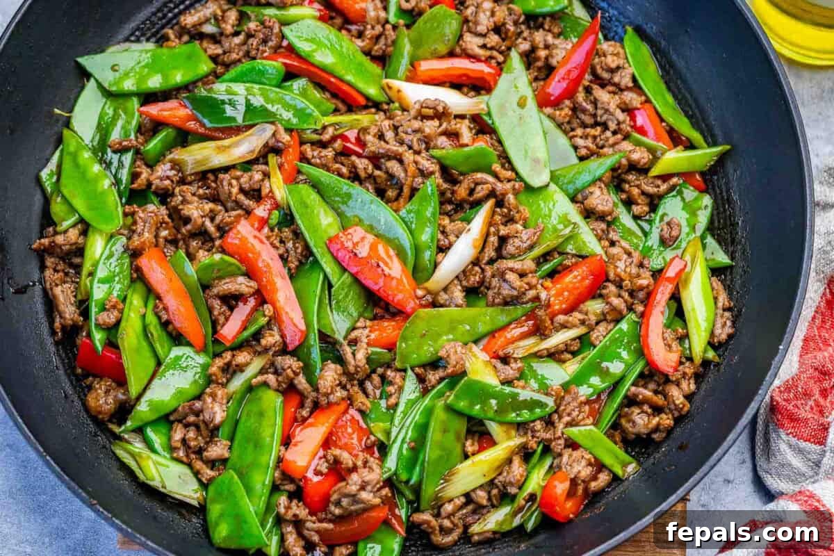 Beef stir fry with veggies in a pan.