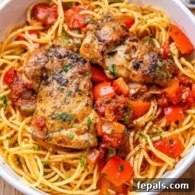 Weeknight Boneless Chicken Thigh Recipes 11 chicken cacciatore over spaghetti in a bowl.