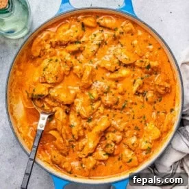 Weeknight Boneless Chicken Thigh Recipes 13 a skillet with chicken bites cooked in a creamy orange paprika sauce.