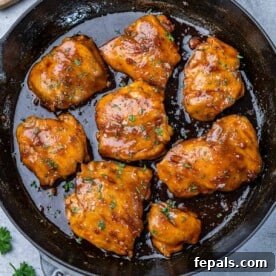Weeknight Boneless Chicken Thigh Recipes 8 top view of seared adobo chicken thighs in a black skillet