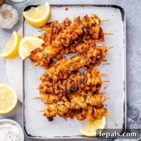 Weeknight Boneless Chicken Thigh Recipes 10 baked chicken skewers on a sheet pan.