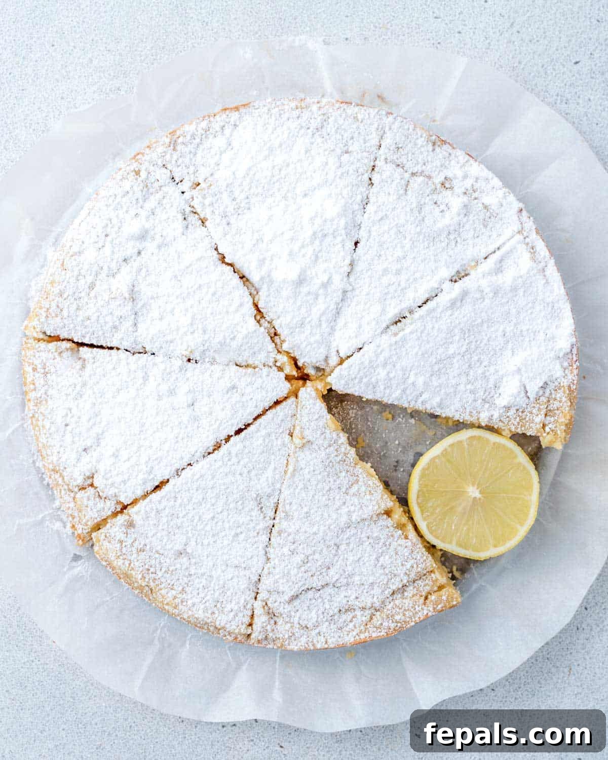 lemon olive oil cake sliced and topped with powdered sugar 