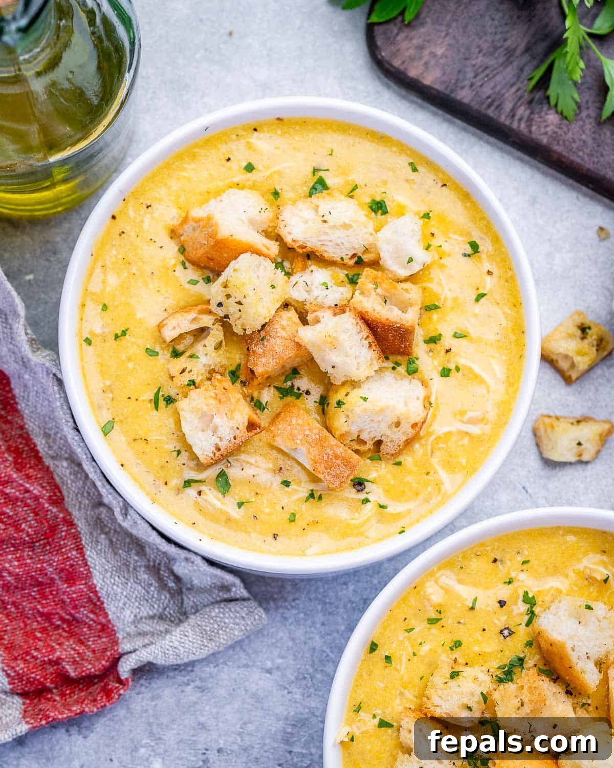 Homemade Cream of Chicken Soup Recipe from Scratch 2 Cream of chicken soup in a white bowl topped with croutons.