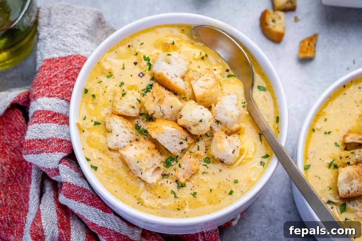 Homemade Cream of Chicken Soup Recipe from Scratch 6 a bowl of cream of chicken soup with wooden spoon in the bowl.