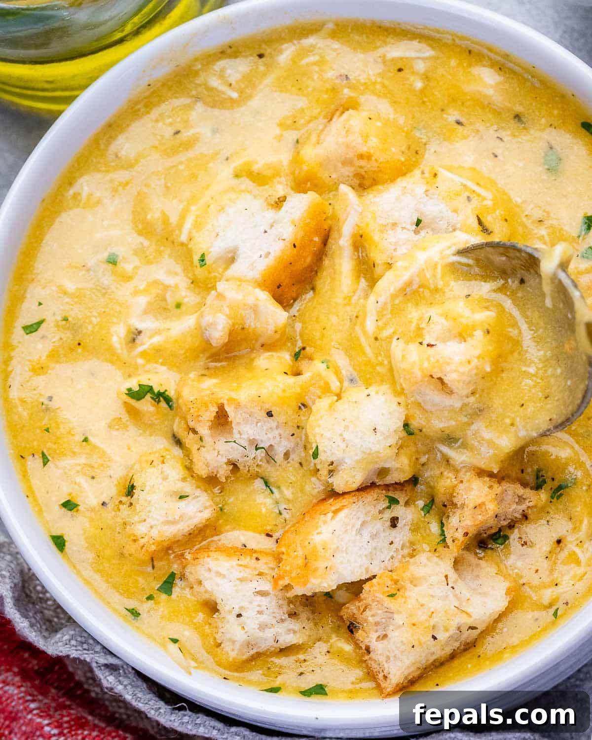 Homemade Cream of Chicken Soup Recipe from Scratch 7 A bowl of homemade cream of chicken soup with a spoon.