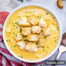 Homemade Cream of Chicken Soup Recipe from Scratch 8 a round white bowl filled with cream of chicken soup topped with croutons.