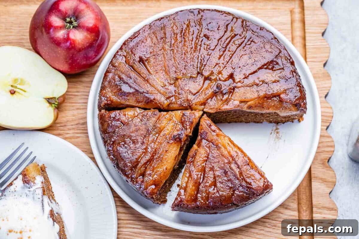 Apple Upside-Down Cake Recipe with Caramelized Apples 6 An apple upside-down cake sliced on a plate.