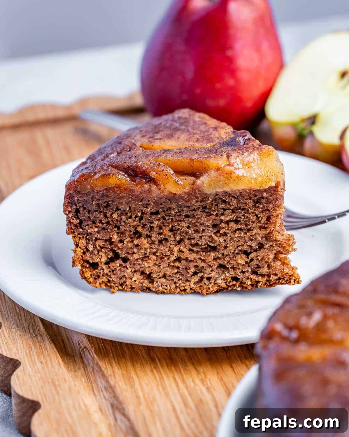 Apple Upside-Down Cake Recipe with Caramelized Apples 7 a slice of cake on a plate.