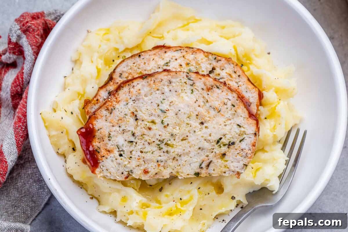 chicken meatloaf slices served over mashed potatoes.