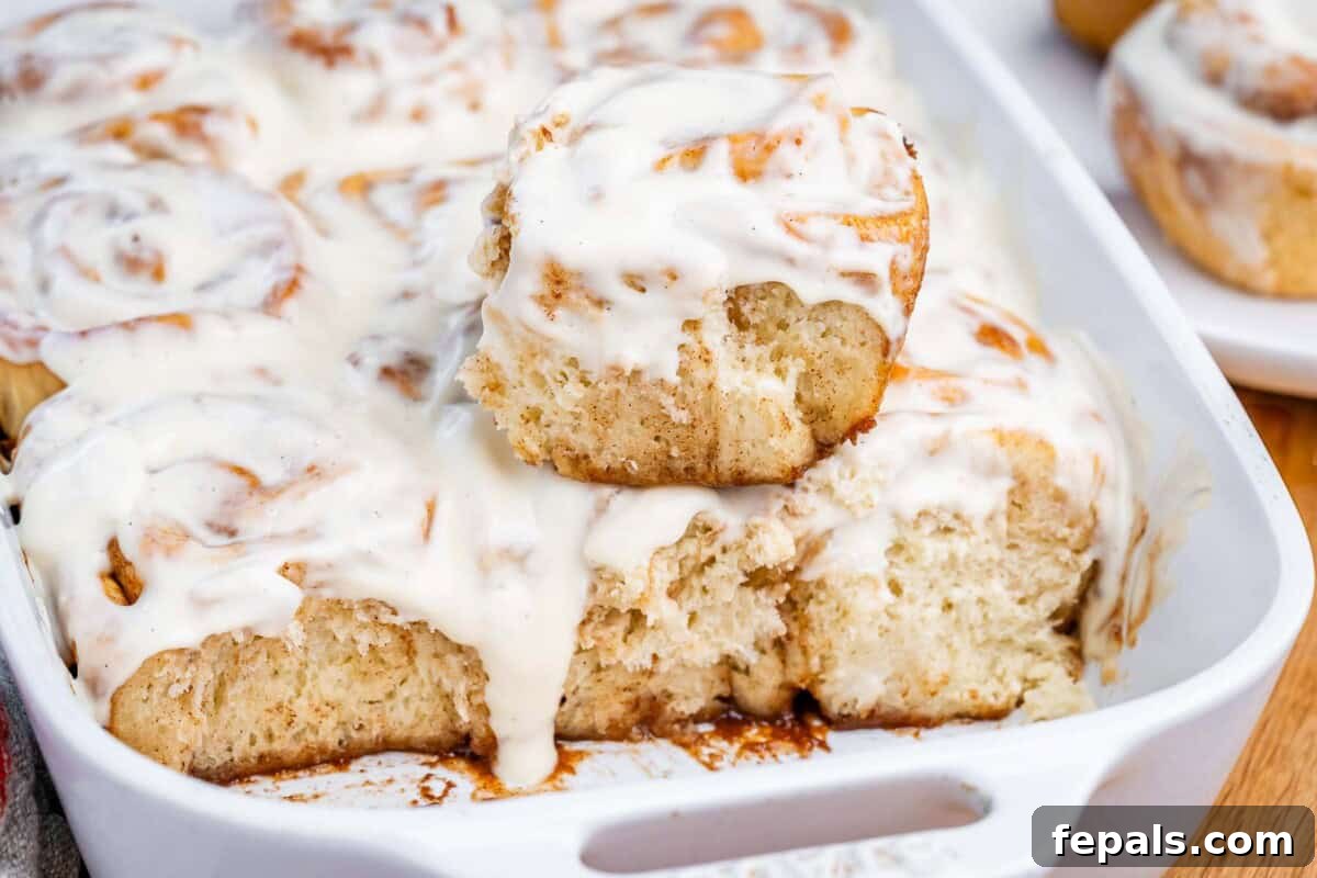 Greek Yogurt Cinnamon Rolls: Soft, Tangy, Homemade 7 Cinnamon rolls in a baking dish.