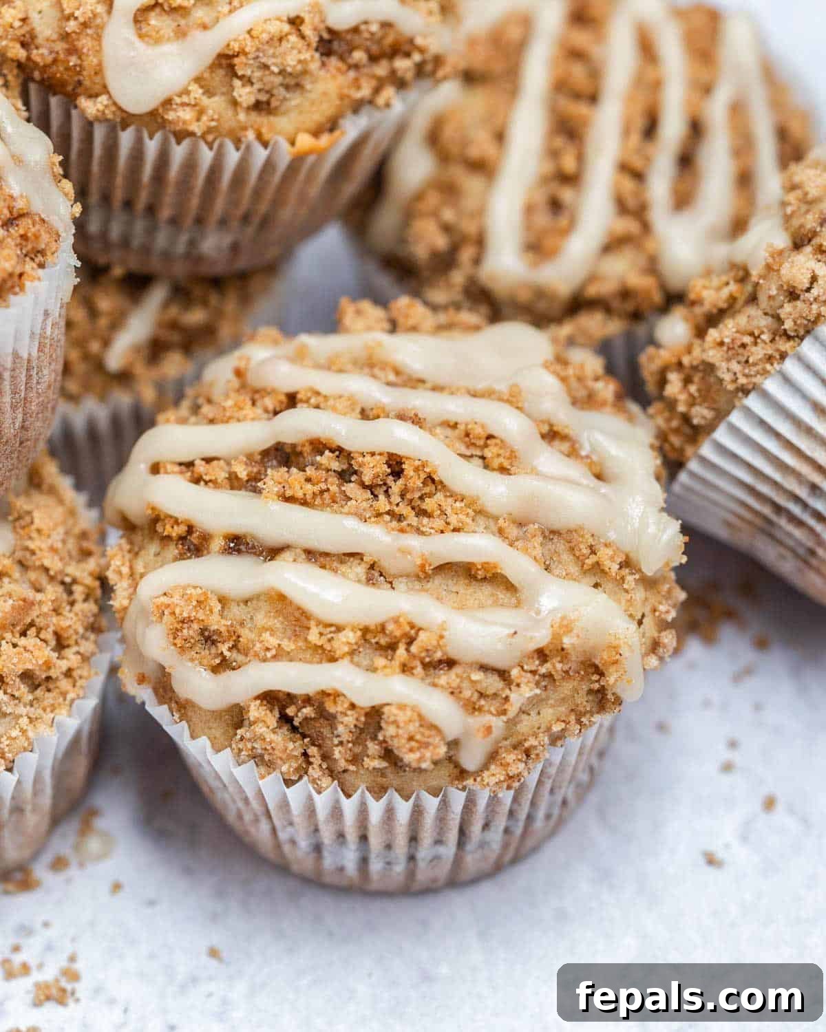coffee cake muffins with a sugar glaze on a flat surface.