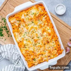 Vegetarian Pasta Recipes for Flavorful Weeknight Dinners 15 Baked pasta in a white baking dish topped with melted cheese.