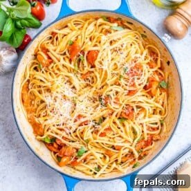 Vegetarian Pasta Recipes for Flavorful Weeknight Dinners 16 Cooked spaghetti fully coated in tomato basil sauce, ready to serve from a round deep skillet.