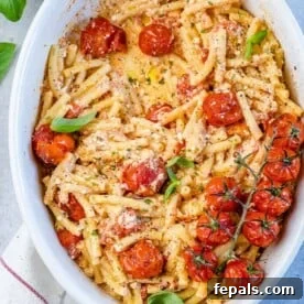 Vegetarian Pasta Recipes for Flavorful Weeknight Dinners 6 tomato and feta cheese pasta on a white dish with roasted tomatoes.