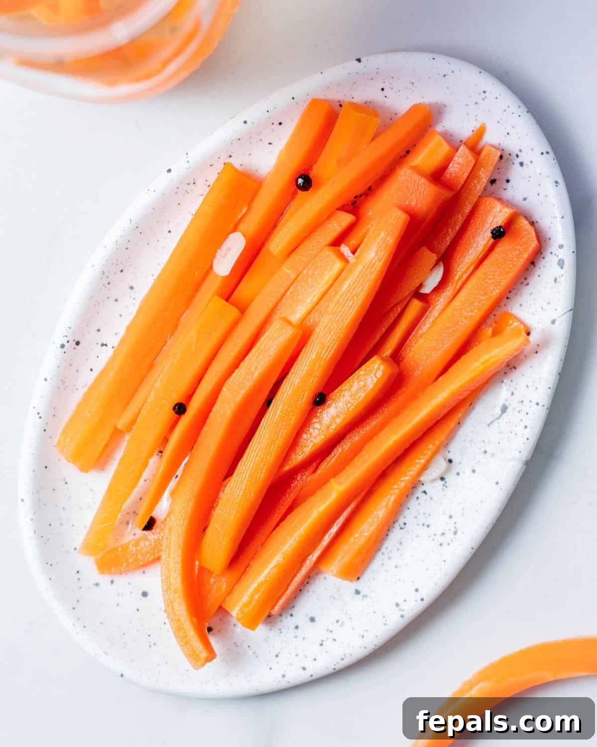Crisp Homemade Pickled Carrots - Refrigerator Pickles Recipe 2 a plate with pickled carrot sticks.