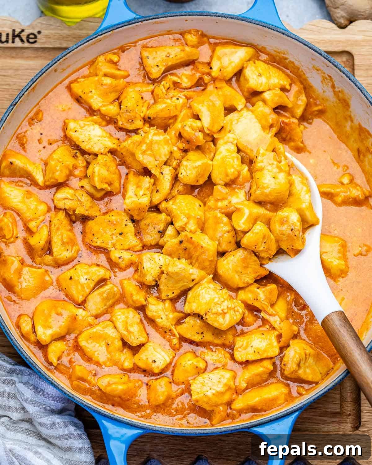Creamy Chicken Korma with Greek Yogurt 2 a pan with chicken korma and a spoon in it.