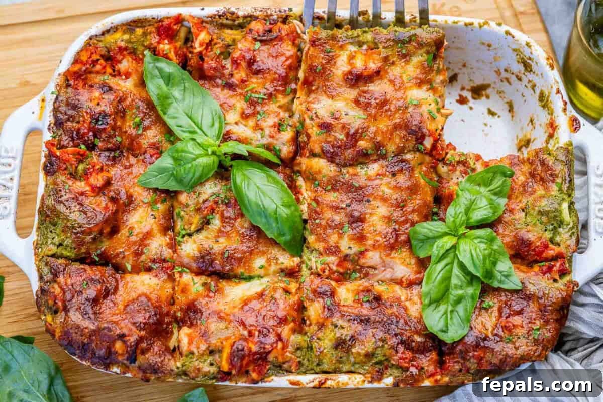 Creamy Chicken Lasagna with Cottage Cheese Recipe 7 chicken lasagna in a dish with a portion taken off.