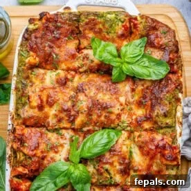 Creamy Chicken Lasagna with Cottage Cheese Recipe 9 chicken lasagna in a dish topped with some fresh basil leaves.
