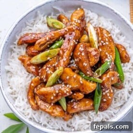 close up top view of mongolian chicken serve over a bowl of rice