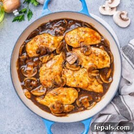 Chicken Marsala in a mushroom sauce in a pan.