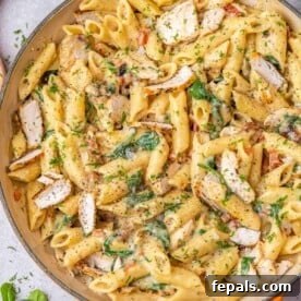 chicken and spinach pasta in an orange dish