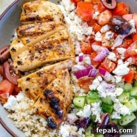 Close image of Greek chicken bowl with veggies