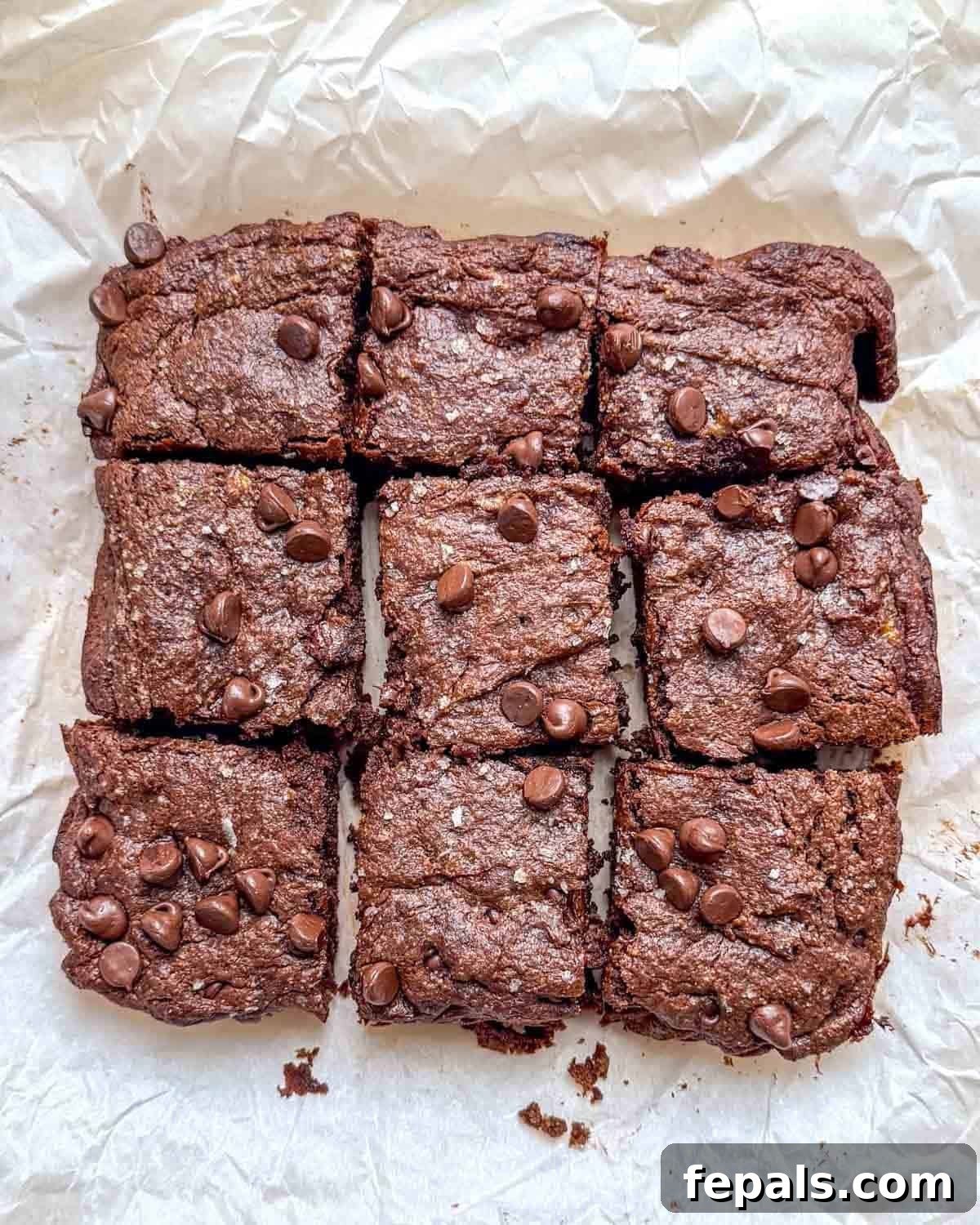 brownies cut into squares on a parchment paper.